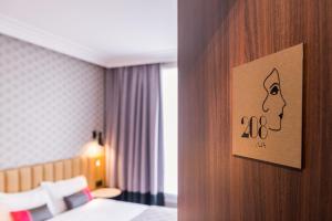 a hotel room with a picture of a face on the wall at Best Western Select Hotel in Boulogne-Billancourt