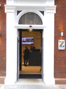 a man standing in front of a door in front of a building at The Z Hotel Covent Garden in London