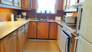 a kitchen with wooden cabinets and a sink at Struer Town House in Struer