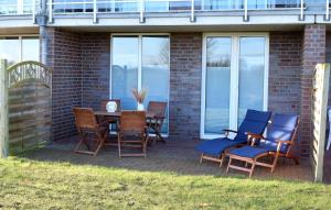 eine Terrasse mit Stühlen, einem Tisch und Stühlen in der Unterkunft Ferienwohnung Gaffelschoner in Hohen Wieschendorf