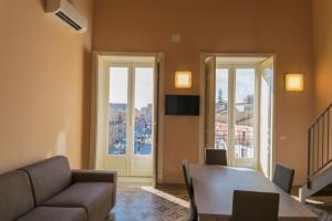 a living room with a table and a couch at Badiula Flat in Lentini