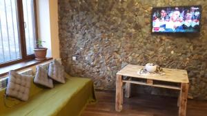 a living room with a couch and a table and a tv at Эдельвейс in Tsaghkadzor