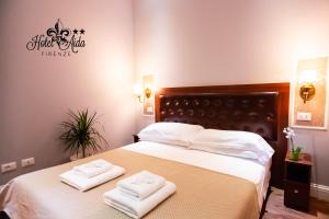 Postel nebo postele na pokoji v ubytování Hotel Aida