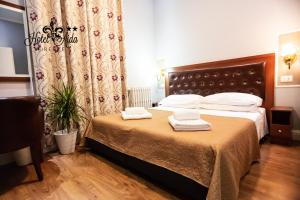 Postel nebo postele na pokoji v ubytování Hotel Aida