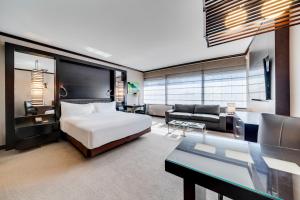 a bedroom with a bed and a living room at Jet Luxury at The Vdara in Las Vegas