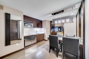 a kitchen with a table and chairs in a room at Jet Luxury at The Vdara in Las Vegas