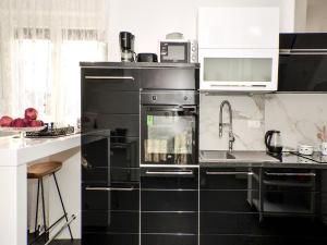 Kuchyň nebo kuchyňský kout v ubytování Deluxe Apartman Porto