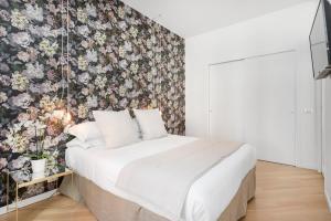a bedroom with a bed with a floral wallpaper at iFdM Mignanelli Suite in Rome