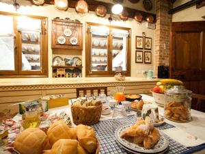 a kitchen with a table with bread and other foods at B&B Asolo Casapagnano in Asolo +22 photos