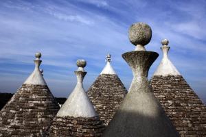 a group of three towers with a cross on top at Masseria Peppeturro in Cisternino