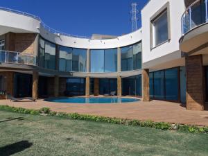 a large house with a swimming pool in front of it at Alaçatı Çınar Boutique Hotel in Alaçatı