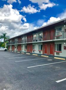a large parking lot in front of a motel at Red Carpet Inn Kissimmee in Kissimmee