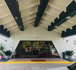 a building with a large glass door and stairs at Red Carpet Inn Kissimmee in Kissimmee