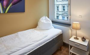 Ένα ή περισσότερα κρεβάτια σε δωμάτιο στο Apartments 4 YOU - Goethestraße