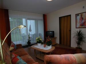 Ferienwohnung am Junkerbült في باد سفيشنآن: غرفة معيشة مع أريكة وطاولة بالنباتات