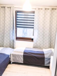 Posteľ alebo postele v izbe v ubytovaní Apartament SONIA