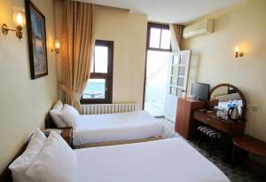 a hotel room with two beds and a television at Hotel Historia-Special Category in Istanbul