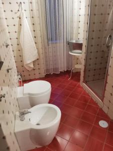 a bathroom with a white toilet and a sink at B&B VICOLO STRETTO in Salerno +26 photos