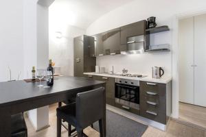 a kitchen with a counter and a table with chairs at Santa Croce Studio in Florence