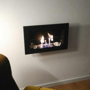 a fireplace on the wall with three candles in it at Sossego e tranquilidade - Valley Guest House - Perto de Lisboa in Arruda dos Vinhos