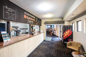 a fast food restaurant with a counter and a bar at Villawood Hotel in Villawood
