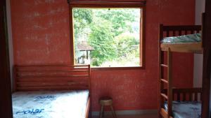 a room with a window and a bunk bed at Duplex com piscina in Paraty +30 photos