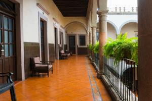 a large room with a walkway leading to a balcony at Hotel Hidalgo in Querétaro