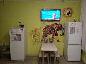 a room with two refrigerators and a tv on the wall at KashEmir in Kyiv