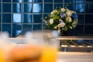 a vase with a bouquet of flowers on a table at Dorotea Luxury Rooms in Ipsos +62 photos