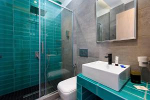 a bathroom with a sink and a glass shower at Dorotea Luxury Rooms in Ipsos