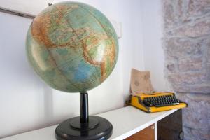 a globe on a table next to a keyboard at Apartment Happy - in the center in Split