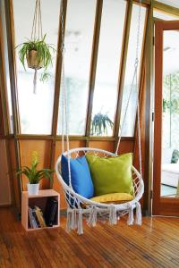 a hanging chair with pillows in a room at The Steady in Los Angeles