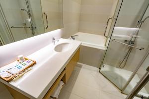 a bathroom with a sink and a shower at Eusta Motel in Taichung