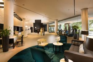 a lobby of a hotel with couches and chairs at PARKROYAL Darling Harbour, Sydney in Sydney