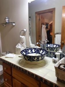 a bathroom with two sinks and a large mirror at River ' s Edge Inn in Brownwood