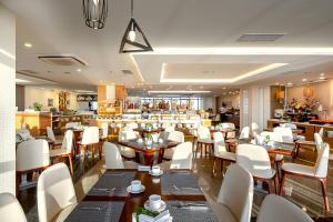 a restaurant with tables and chairs and a bar at The Nalod Da Nang in Danang
