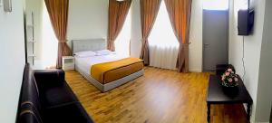 a bedroom with a bed and two windows at Melaka Homestay Tiara Golf Resort in Malacca