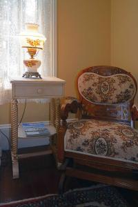 a chair and a lamp in a room at 1872 Denham Inn in Monticello