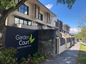 a building with a sign that reads garden court at Garden Court Suites & Apartments in Queenstown