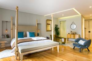 a bedroom with a bed and a blue chair at Marchesa Da Bica Luxury in Lisbon