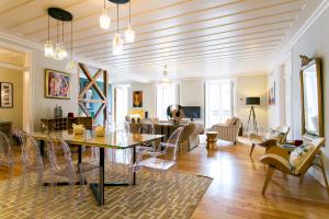a living room with a table and chairs at Marchesa Da Bica Luxury in Lisbon