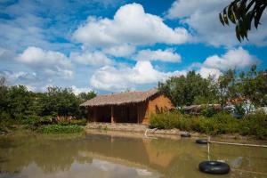 a house in the middle of a body of water at Mekong Rustic Cai Be in Cai Be