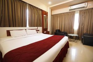 um quarto de hotel com uma cama grande num quarto em HOTEL EXCELLENCY em Bhubaneshwar
