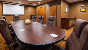 a conference room with a large wooden table and chairs at Best Western Plus Finger Lakes Inn & Suites in Cortland