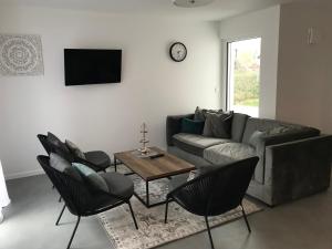 a living room with a couch and chairs and a table at Ferienhaus Albert in Owingen