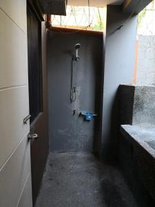 a bathroom with a shower in the corner of a room at Anabelle Residence in Dumaguete +27 photos
