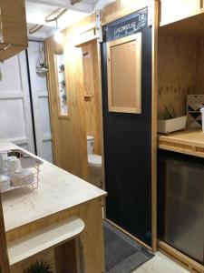 a kitchen with a black door in a trailer at SEA-green in Nelly Bay