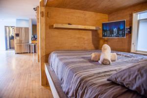 a bed with a stuffed animal sitting on top of it at PodShare Venice in Los Angeles