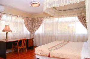 Postel nebo postele na pokoji v ubytování Fang Fang Hotel