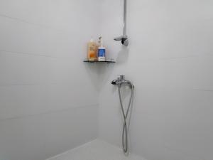 a shower in a white wall with a shower head at Slow Citi Guest House -슬로시티게스트하우스 in Seogwipo +44 photos
